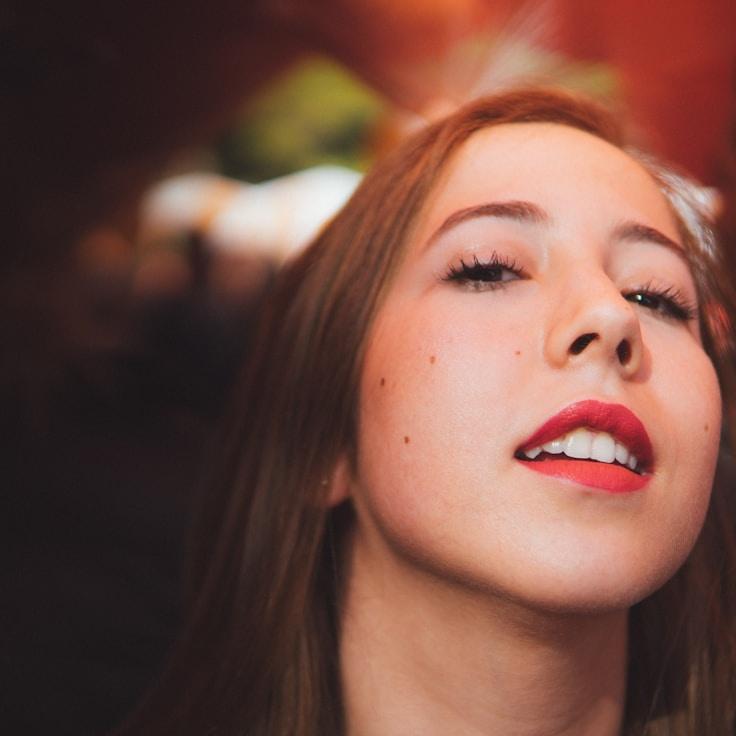 Kaveri Mehta, Lead Design Curator at LumenQuartzHarbor, reviewing corporate floral arrangements